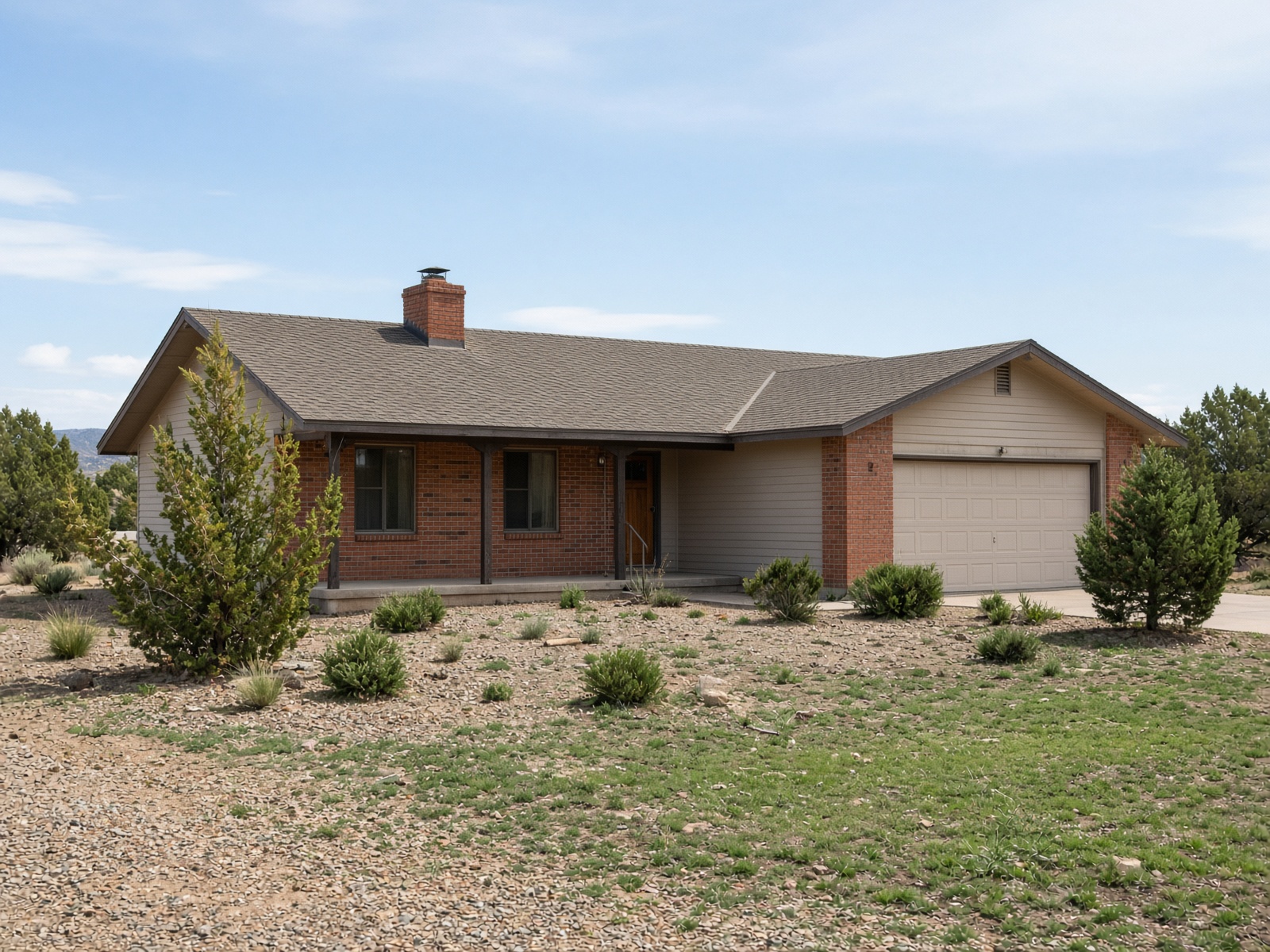 Classic western rambler ranch house with a low-pitch shingle roof