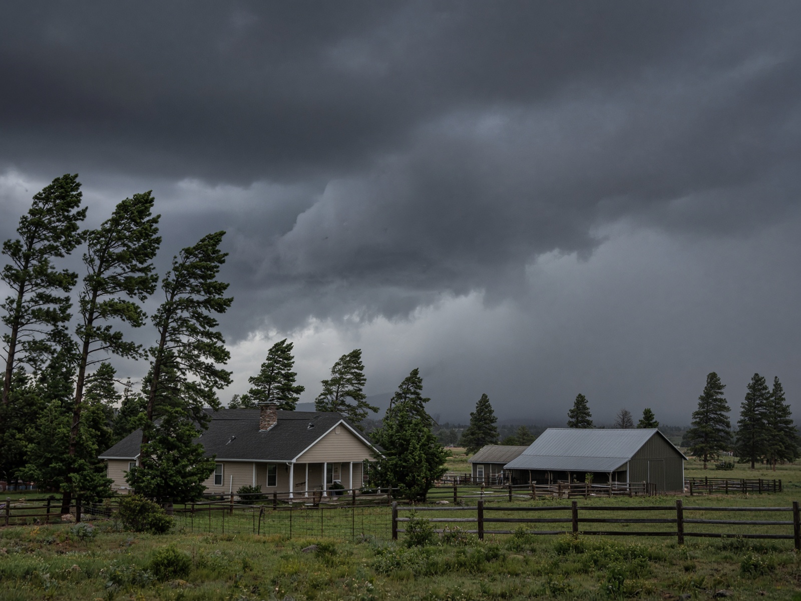 Monsoon storm over a country ranch house and barn